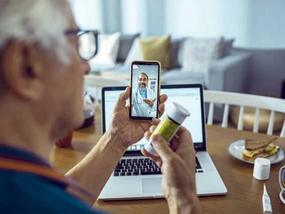 A patient talks about blood pressure with a doctor using telehealth