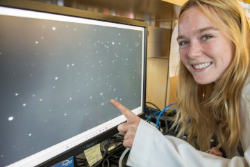 Remi Bliss, physiology & medical sciences undergraduate, shows how exosomes are visualized on a computer monitor