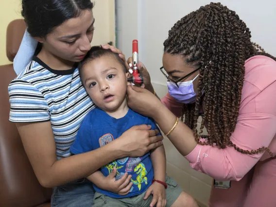 underserved mother, child and doctor