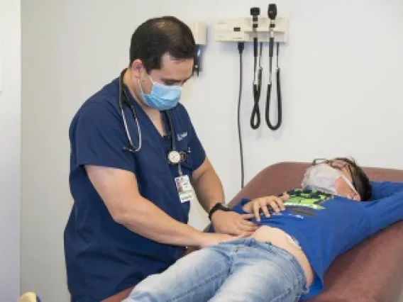 Doctor with patient on examining table