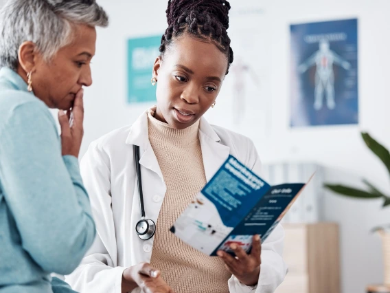 Female African-American doctor consulting with a patient.