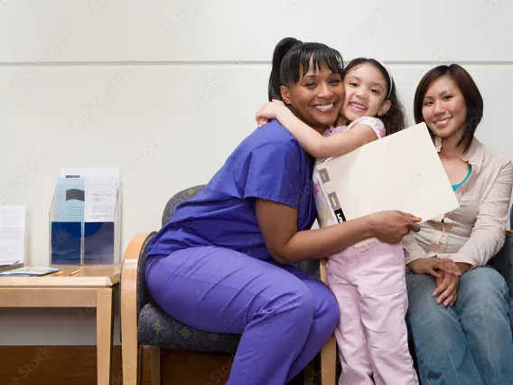 Doctor, child and mother happy after their pediatric appointment.