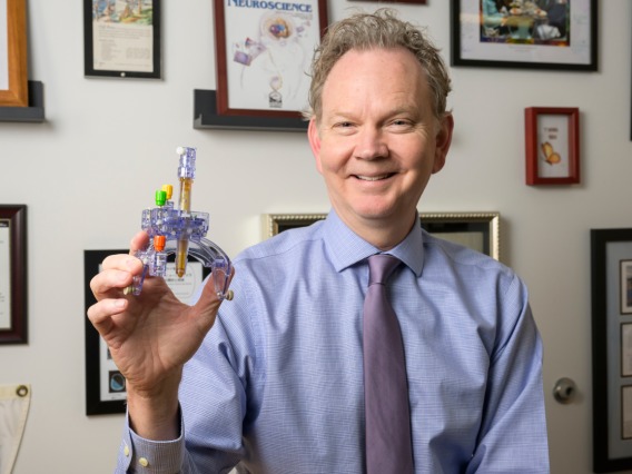 Paul Larson helped develop a device that temporarily attaches to the skull to pinpoint a precise location in the brain.