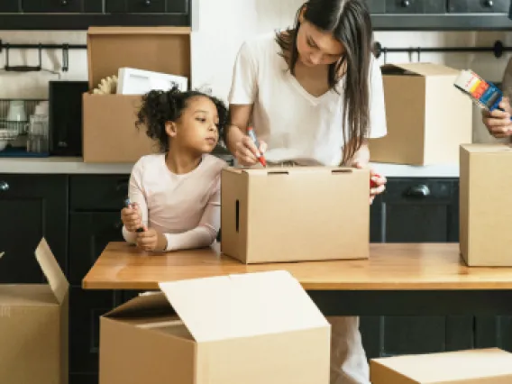 mom and daughter packing boxes