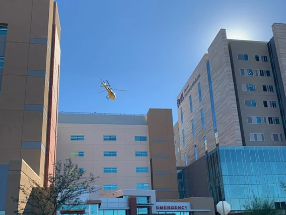 Emergency helicopter flies toward rooftop landing spot