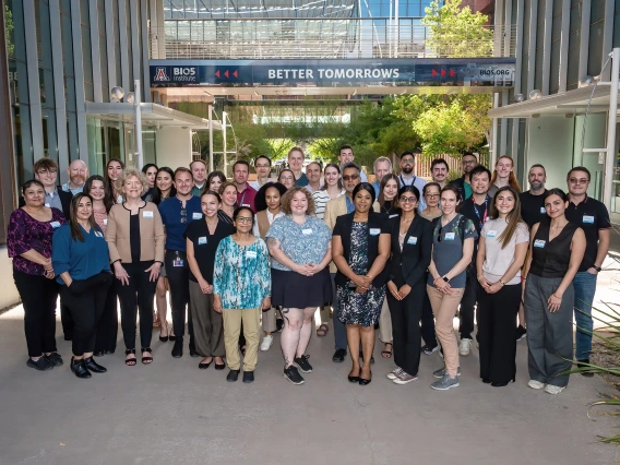 [Attendees at the Share Opportunities & Achievements in Research, or SOAR, in the Department of Medicine forum gather for a group photo between the Biomedical Research Building and Keating BioResearch Building – also the home of the BIO5 Institute.]