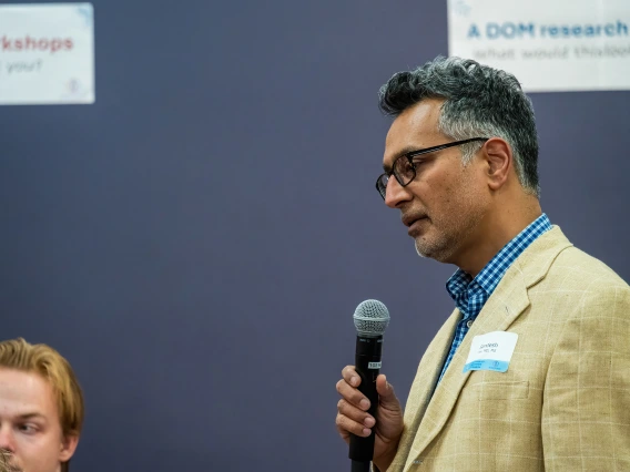 [Sandesh Dev, MD, a Division of Cardiology associate professor and associate chief of staff for research at the Southern Arizona VA Health Care System, frames the breadth of his research for attendees of the SOAR in the DOM Forum.]