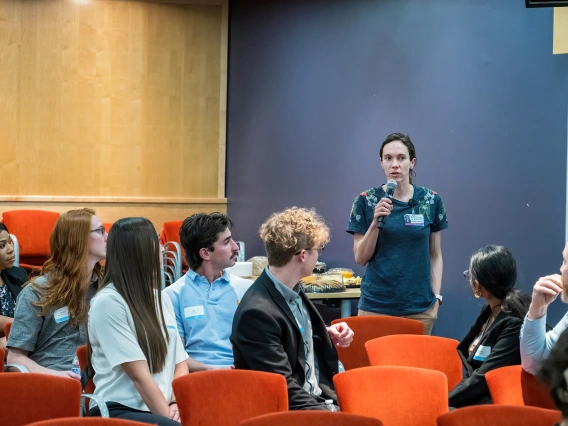 [Anna Morenz, MD, whose research in the Division of General Internal Medicine, Geriatrics & Palliative Medicine centers on improving cancer screening practices to reduce disparities, talks to other attendees at the SOAR in the DOM research forum. She won a Junior Faculty Excellence in Research Award at the forum.]
