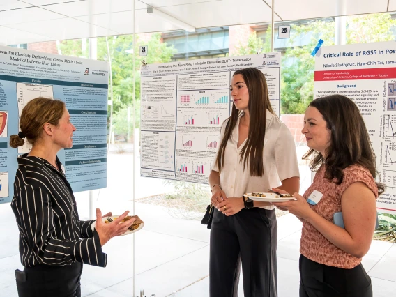 [Division of Endocrinology’s Jennifer Stern, PhD, talks to two people interested in expanding their experience in biomedical research at the University of Arizona at the SOAR in the DOM Forum.]