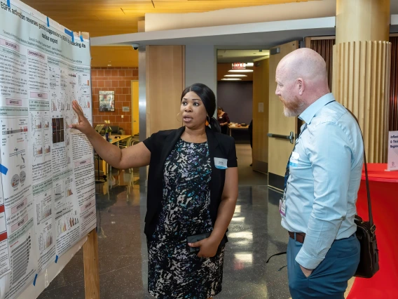 [Uloma Elvis-Offiah, a cancer biology and physiological sciences PhD candidate, talks with the Pulmonary division’s Franz Rischard, DO, about her research on gastrointestinal genetic mutations and neuroendocrine tumors, particularly gastrinomas. She won the forum’s Excellence in Research Award.]