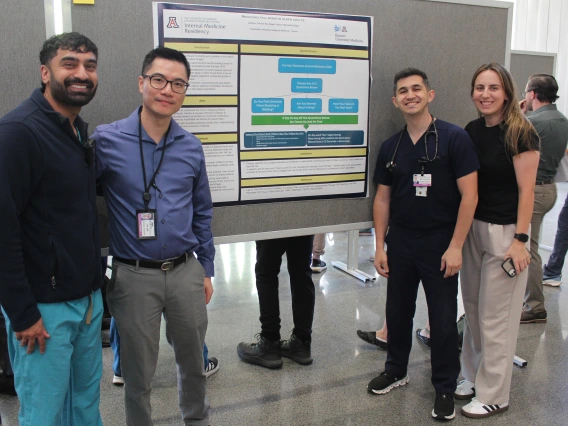 [PGY-3s Clinton Wu, DO, and Biagio Collura, MD, on either side of their poster, “Reducing Fall Risks in Older Adults,” with colleagues. Geriatrics’ Meenakshi Dagar, MD, was co-author on the research.]