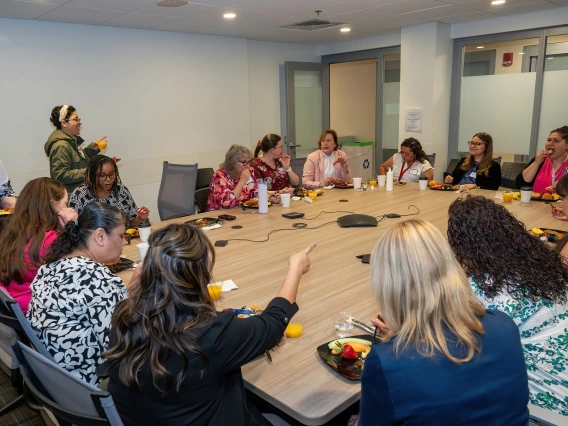 [Department of Medicine admins gather around the Conference Room 6416 table to celebrate the 2025 DOM Administrative Professionals Day breakfast on April 23.]