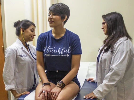 resident with attending physician and patient