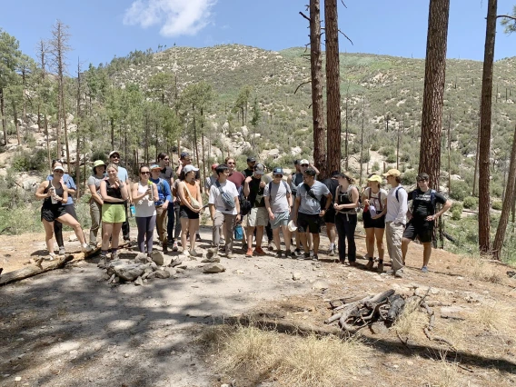 [A group of interns with chief residents Tyler Gloe, DO, and Josh Sethi, MD, MS, in the Catalina Mountains north of Tucson for a teambuilding hike in cooler weather. Temperatures vary from 20-30 degrees cooler on Mount Lemmon.]