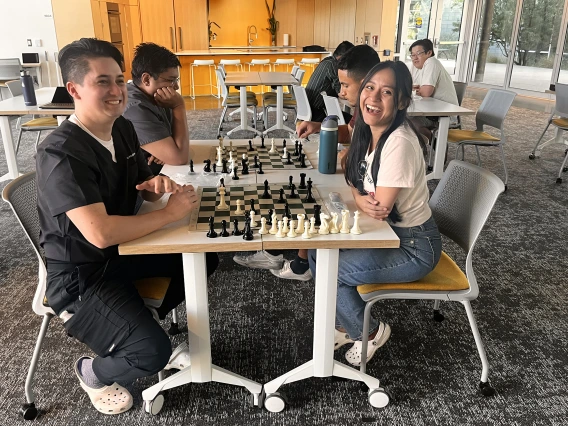 [Nathan Holt, DO (PGY-1 radiology resident – in black top), and his wife laugh about the turn of events in their chess match.]