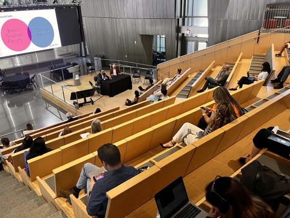 [CTDW co-leaders Jarrod Mosier, MD, and Franz Rischard, DO (seated at table onstage), discuss the practicalities intertwined between clinical faculty and basic science faculty – and the collaborative nature of how that fits into the academic setting at the University of Arizona.]