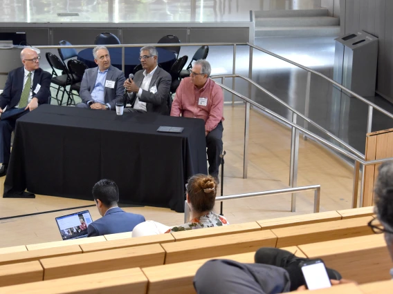 [Panelists discuss the passion that drives researchers as well as benefits of hosting various forums to share related interests among potential collaborators and, in particular to Sairam Parthasarathy, MD (holding microphone), shares early advice he got from a mentor in the first year of his fellowship. That advice was, if you’re a good physician, you may have a great impact on one patient or a dozen patients, but a scientific discovery can broaden that to dozens, hundreds or thousands.]
