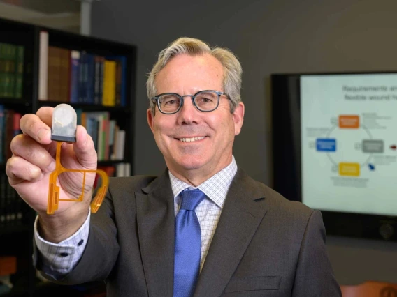 Geoffrey Gurtner, MD, holds up a smart bandage