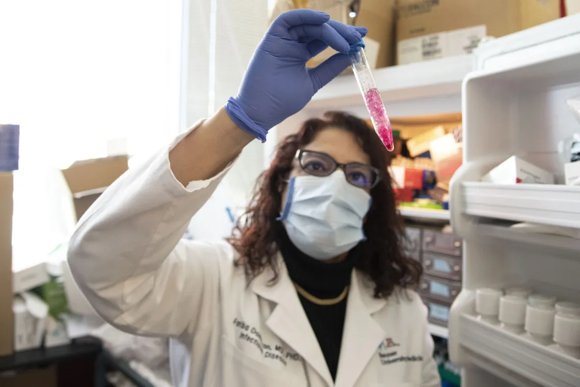 female lab tech examining test-tube 