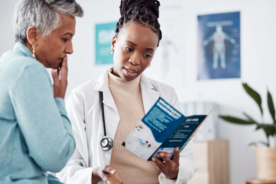 Female African-American doctor consulting with a patient.