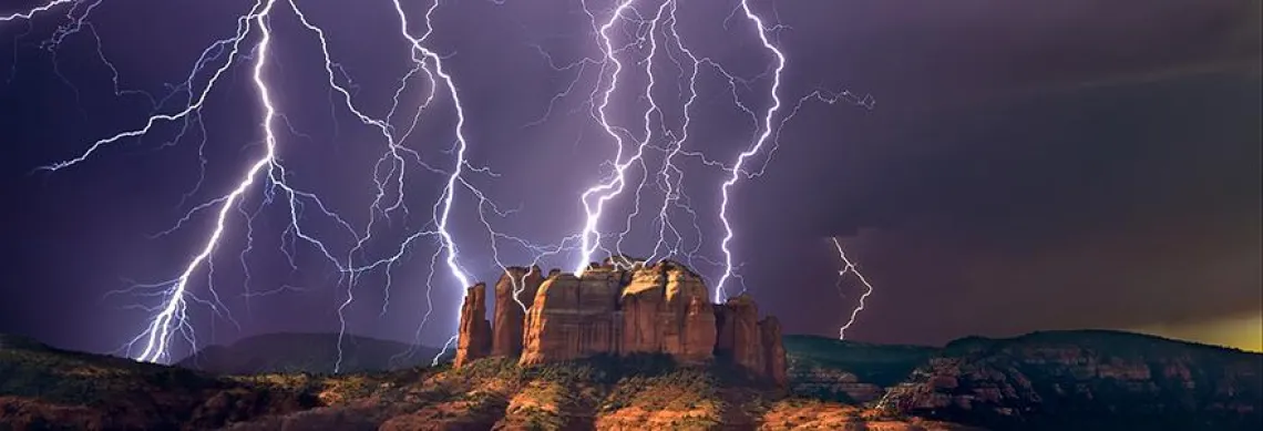 Night photo of lightning striking mountains