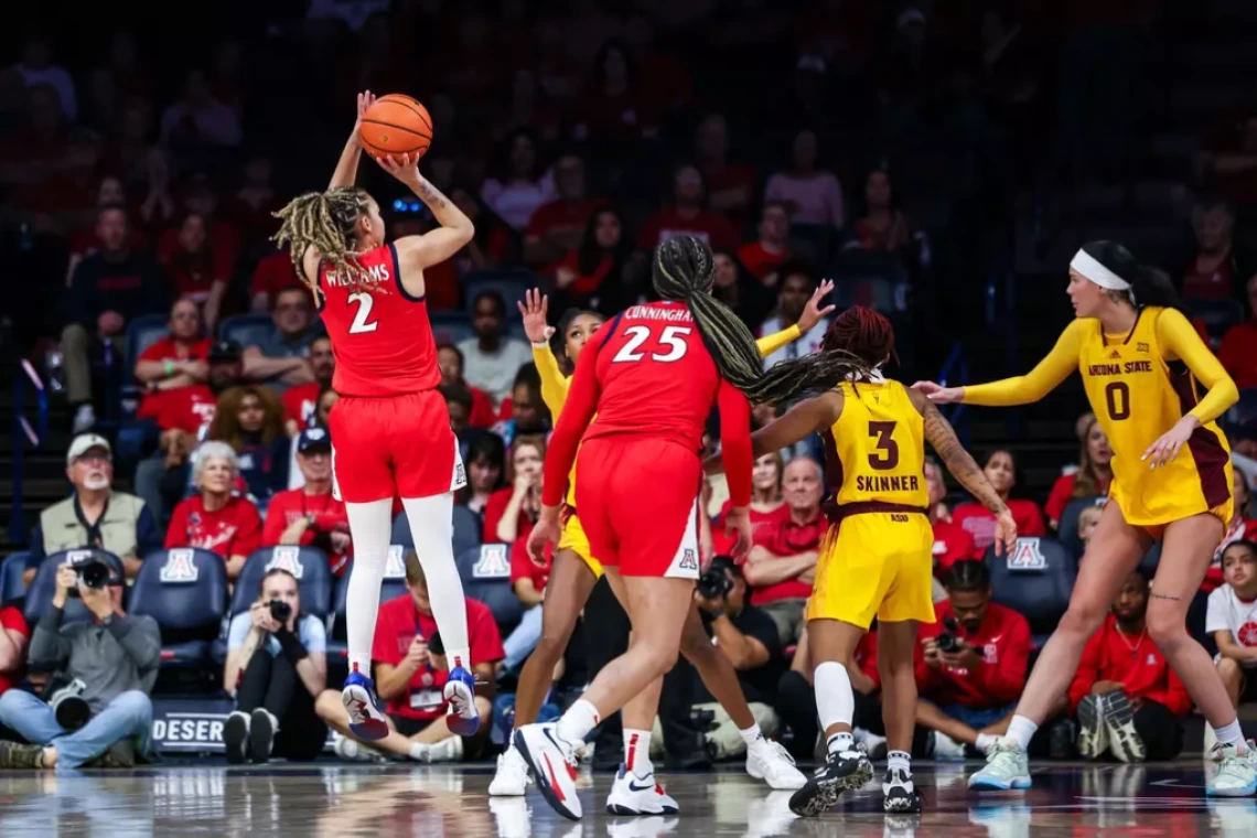 U of A’s Jada Williams (#2), who finished with 18 points, leaps into the air to shoot a basket.
