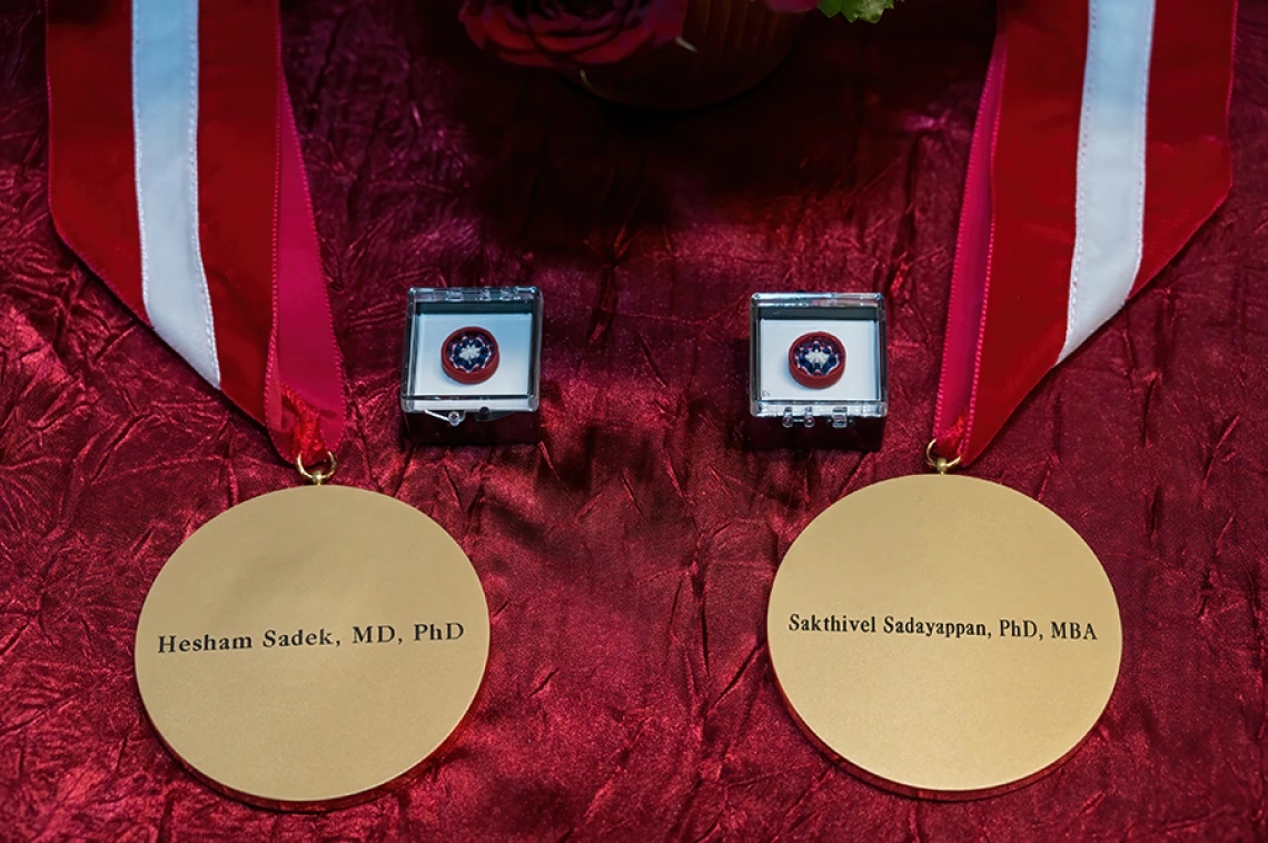 Medallions that accompany an investiture, here emblazoned with the names of Drs. Hesham Sadek and Sakthivel Sadayappan.