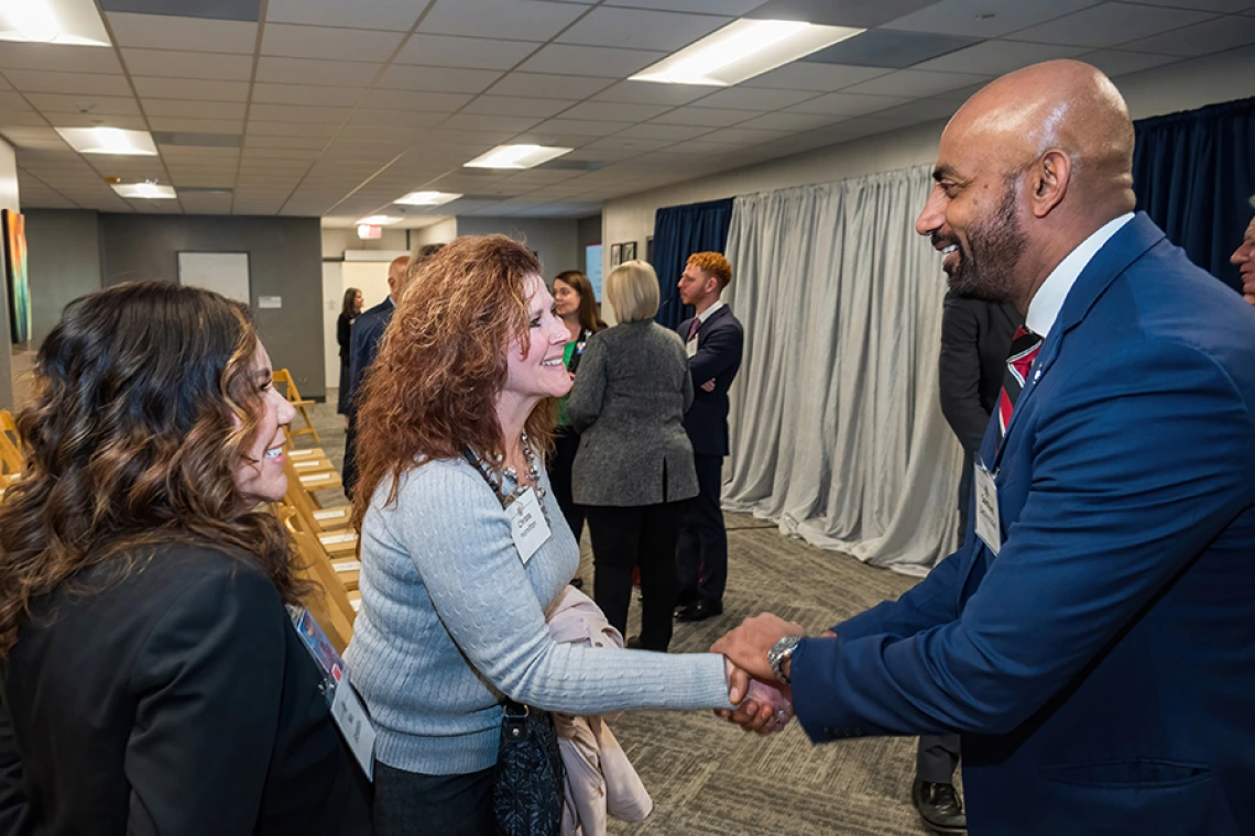 Cellular and Molecular Medicine department chair Sakthivel Sadayappan, PhD, shakes hands with Division of Cardiology’s Christa Hamilton (shaking hands) and Mia Gonzales.
