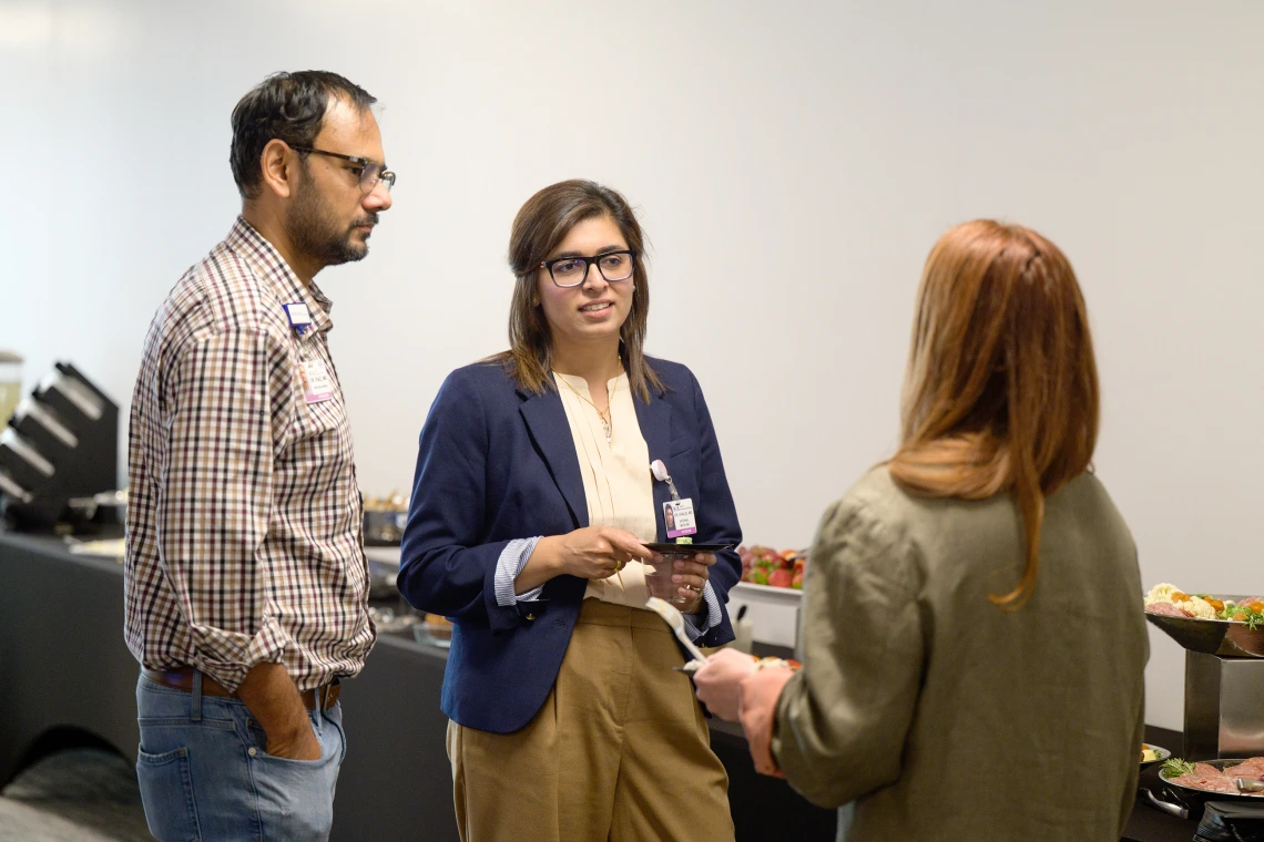 [LAMS Fellow Saher Khalid, MD (center), an internist in the Division of General Internal Medicine, Geriatrics & Palliative Medicine, with her husband, the Division of Infectious Diseases’ Talha Riaz, MD, chatting with fellow fellowship graduate Billie Bixby, MD, from the Division of Pulmonary, Allergy, Critical Care & Sleep Medicine.]
