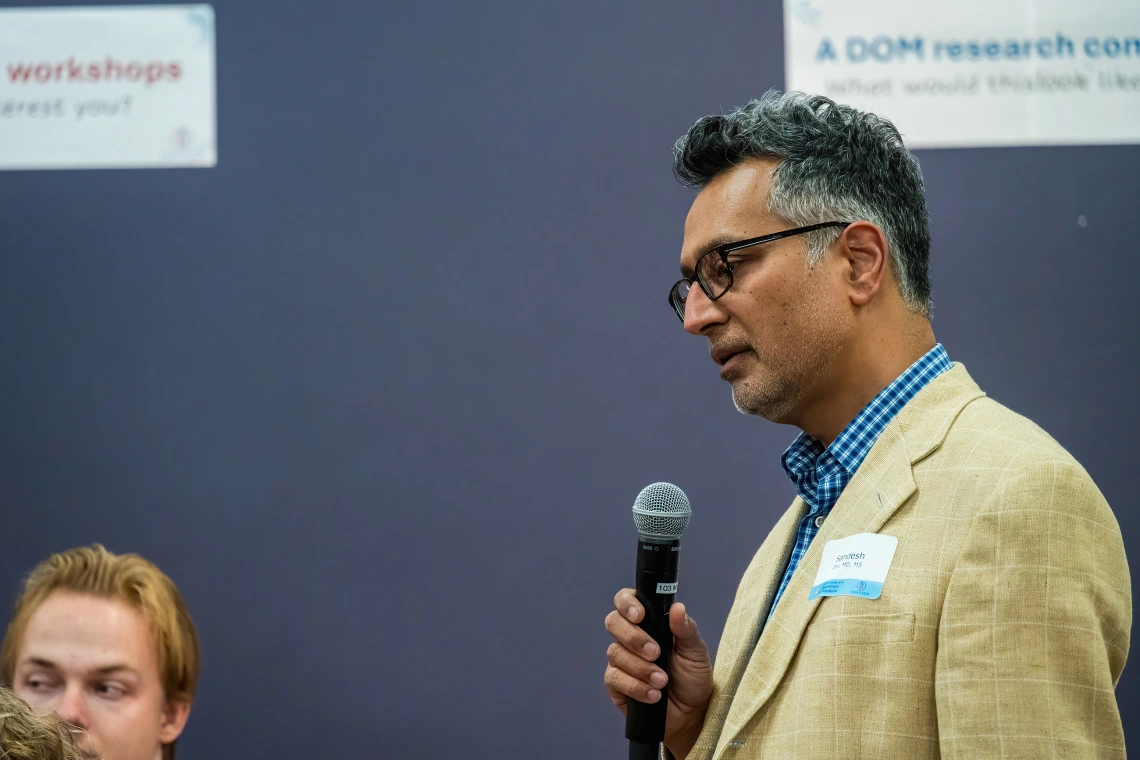 [Sandesh Dev, MD, a Division of Cardiology associate professor and associate chief of staff for research at the Southern Arizona VA Health Care System, frames the breadth of his research for attendees of the SOAR in the DOM Forum.]