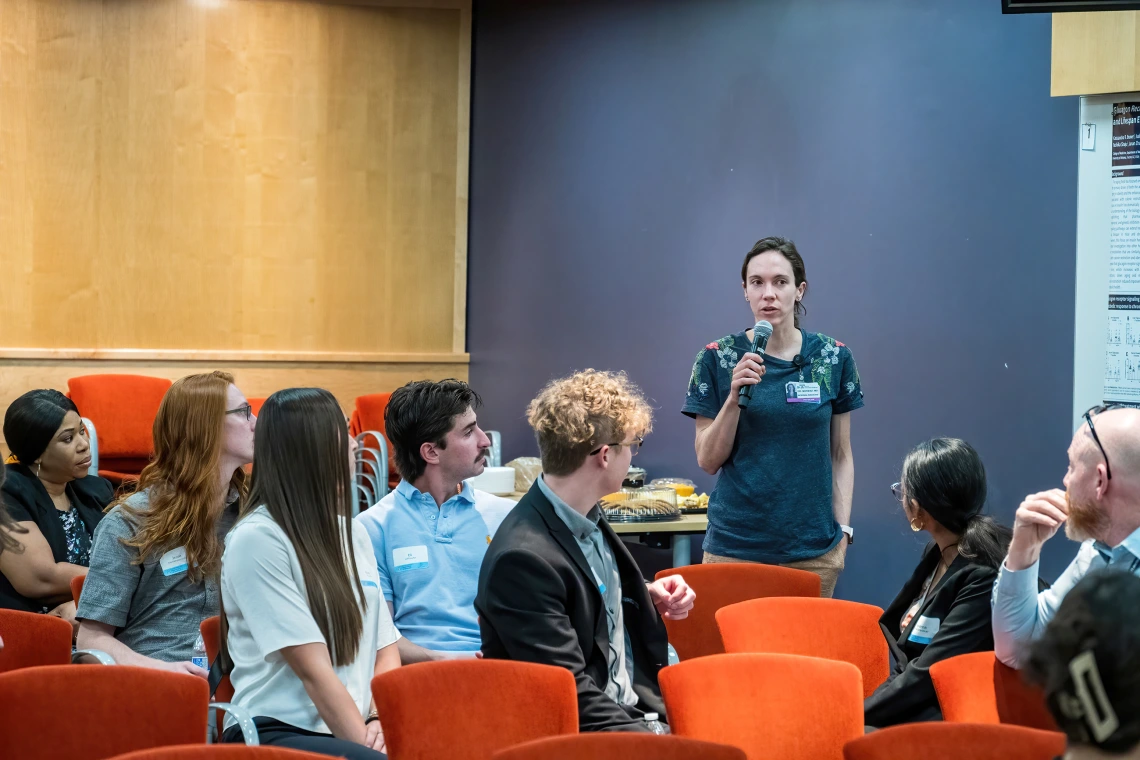 [Anna Morenz, MD, whose research in the Division of General Internal Medicine, Geriatrics & Palliative Medicine centers on improving cancer screening practices to reduce disparities, talks to other attendees at the SOAR in the DOM research forum. She won a Junior Faculty Excellence in Research Award at the forum.]