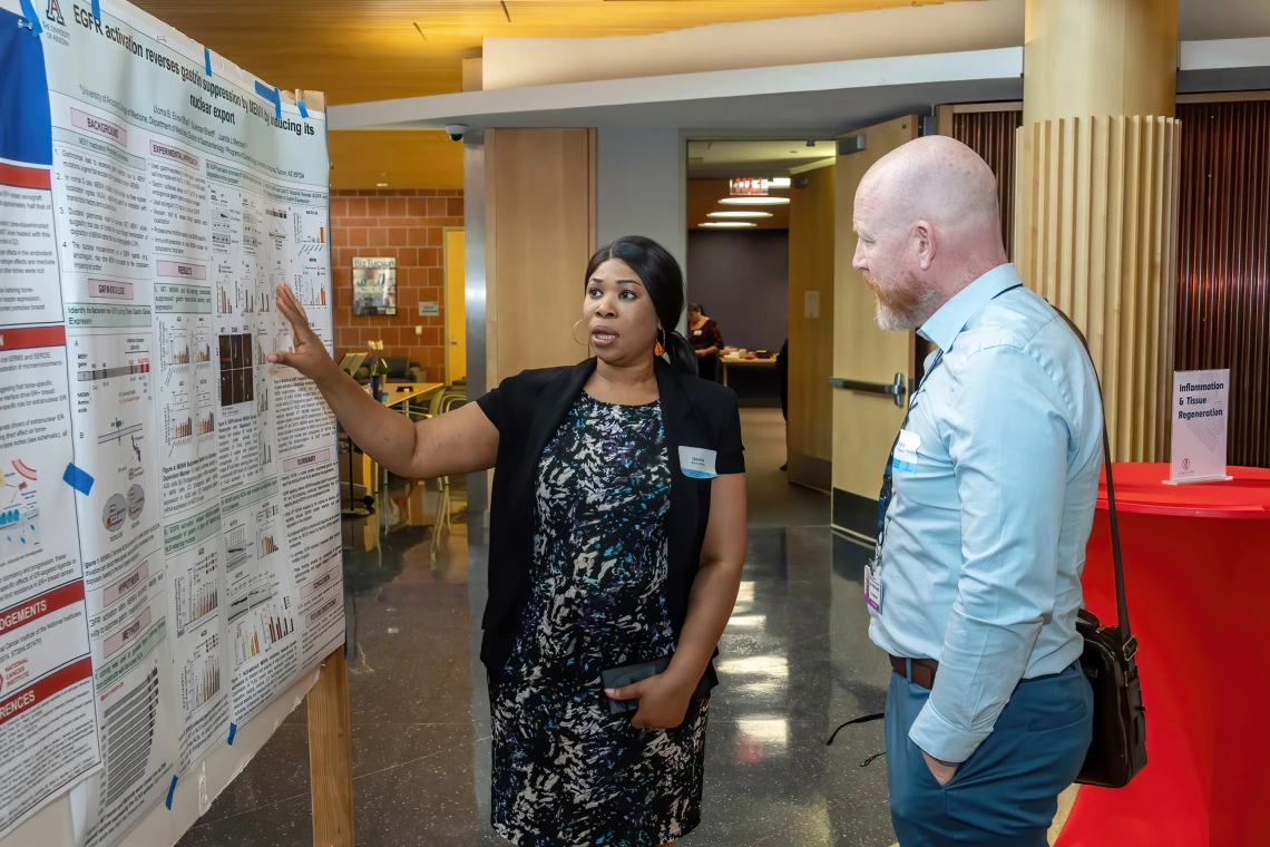[Uloma Elvis-Offiah, a cancer biology and physiological sciences PhD candidate, talks with the Pulmonary division’s Franz Rischard, DO, about her research on gastrointestinal genetic mutations and neuroendocrine tumors, particularly gastrinomas. She won the forum’s Excellence in Research Award.]