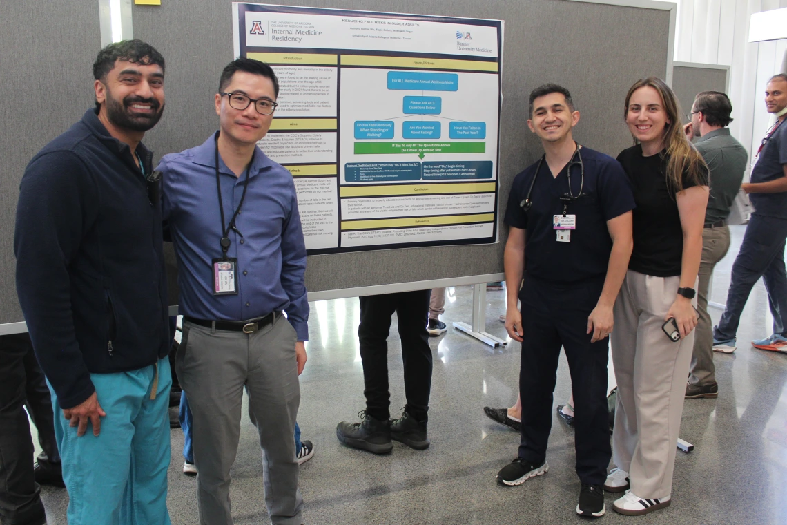 [PGY-3s Clinton Wu, DO, and Biagio Collura, MD, on either side of their poster, “Reducing Fall Risks in Older Adults,” with colleagues. Geriatrics’ Meenakshi Dagar, MD, was co-author on the research.]