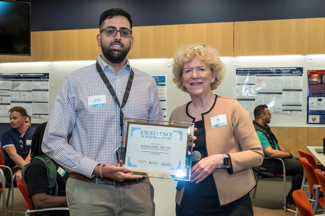 [Joshua Sethi, MD, MS, who won an Excellence in Research Award at the SOAR in the DOM forum, with Janet Funk, MD, DOM vice chair for research.]