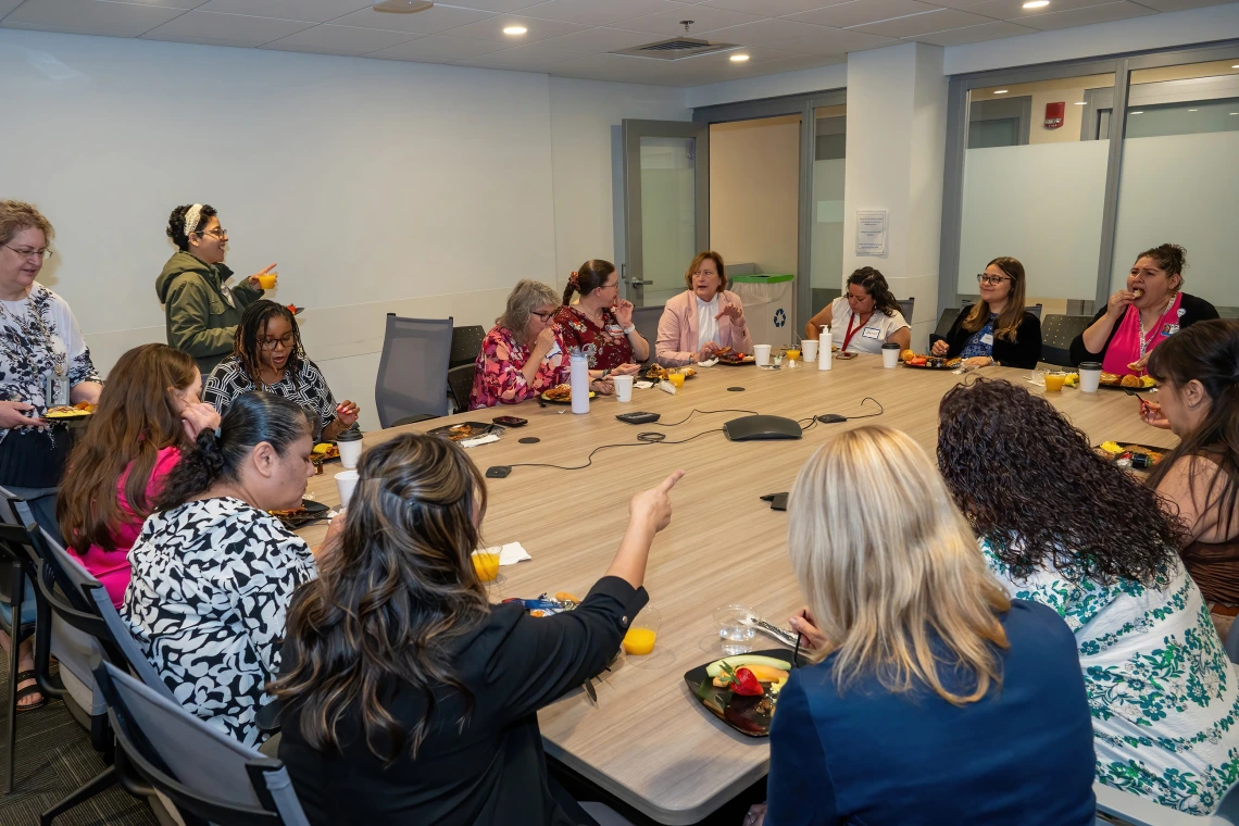 [Department of Medicine admins gather around the Conference Room 6416 table to celebrate the 2025 DOM Administrative Professionals Day breakfast on April 23.]