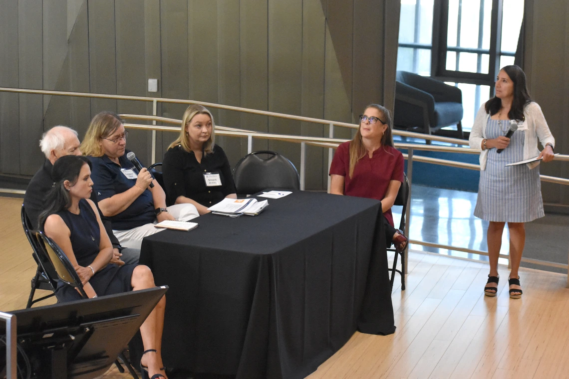 [Christine Gaul, MBA (holding microphone), Research Administration operations director, U of A Health Sciences, discusses how its staff works with investigators and the IRB to ensure that all their documentation and procedures in research meet the highest standards.]