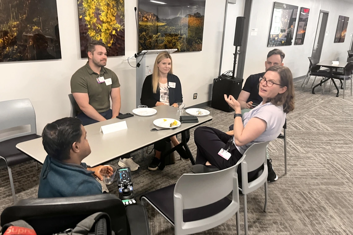 [At the IM Research Mixer, residency program director Laura Meinke, MD, a critical care medicine specialist in the Pulmonary division, chats with IM interns (from left) Khaja Siddiqui, MD, Ryan Schmidt, MD, and Emily Adamson, DO, with Eric Brucks, MD, a Tucson VA Medical Center physician who’s an associate program director for the IM Residency – Tucson program there.]