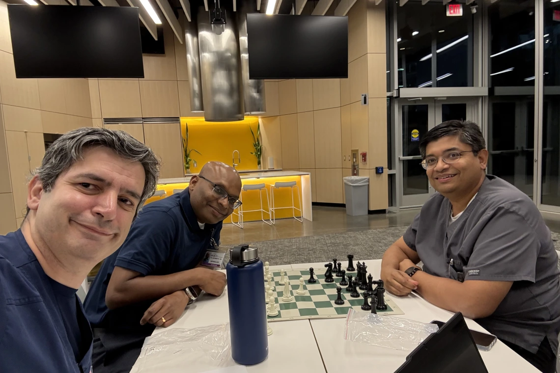[From left, Cardiology’s Talal Moukabary, MD, Nephrology’s Venkatesh Aryamuthu, MD, and Inpatient Medicine’s Anil K. Potharaju, MD — organizers of the evening’s festivities — enjoy a last match of the night, July 7 at the AWCIM Iris Cantor Building: “I was really tired after a long day and still couldn't leave the venue until the doors closed – the people were awesome!” Dr. Potharaju said.]