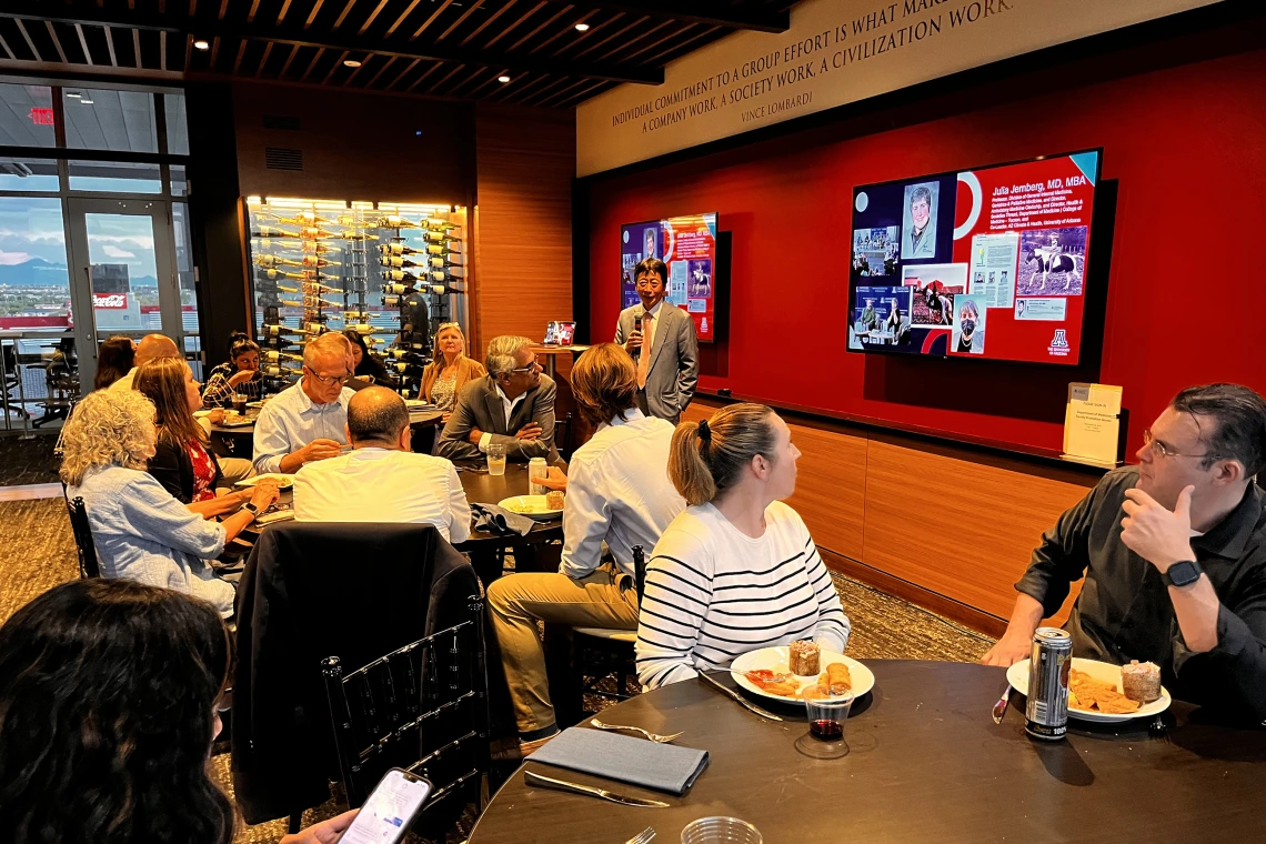 [With photos of geriatrician Julia Jernberg, MD, MBA, onscreen behind him, DOM Chair Jim Liao, MD, starts off the festivities at the 2025 annual DOM faculty promotion fiesta.]