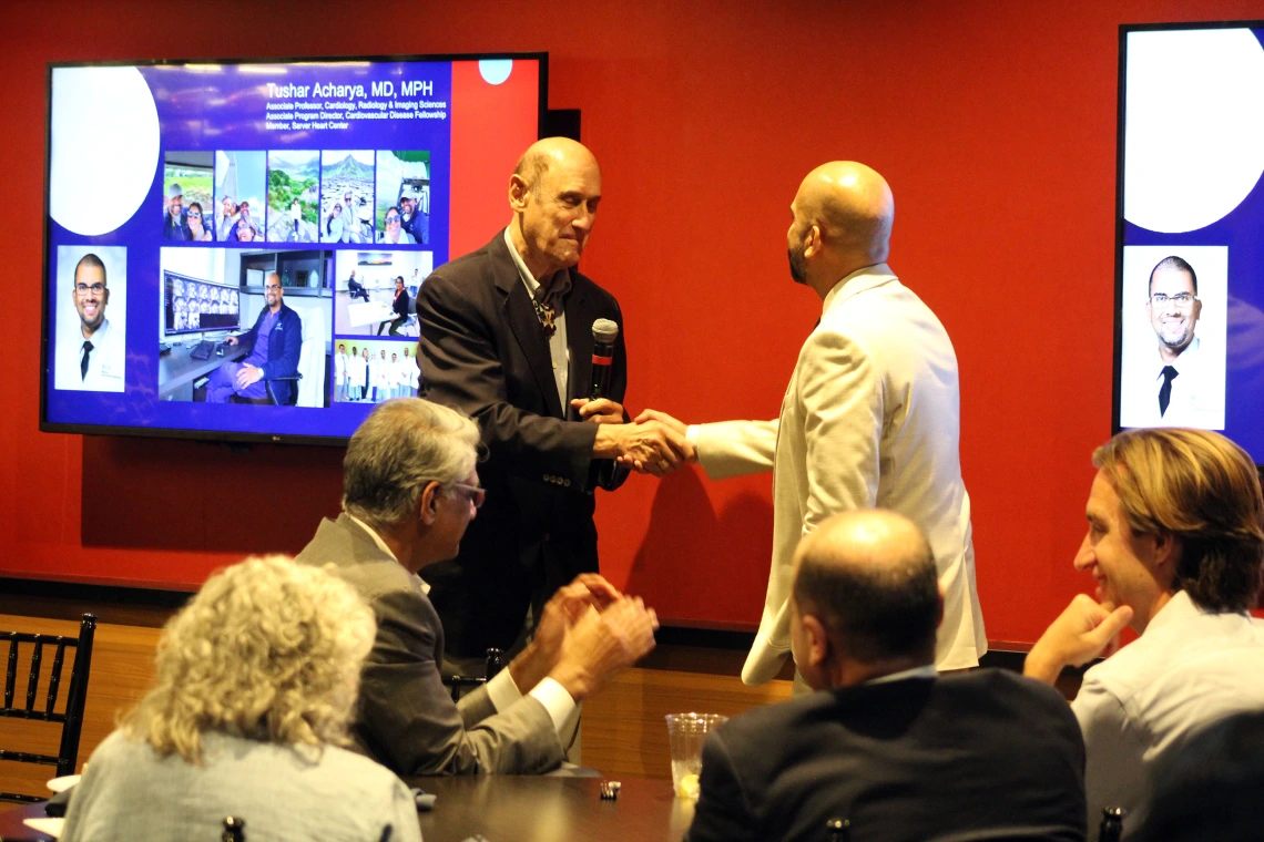 [Tushar Acharya, MD, MPH, listens as the Division of Cardiology’s Joe Alpert, MD, has nothing but kind words for the work he’s done in his roles as medical director of general cardiology for Banner University Medicine – Tucson, program director of the Advanced Cardiovascular Imaging Fellowship and associate program director of the Cardiovascular Disease Fellowship.]