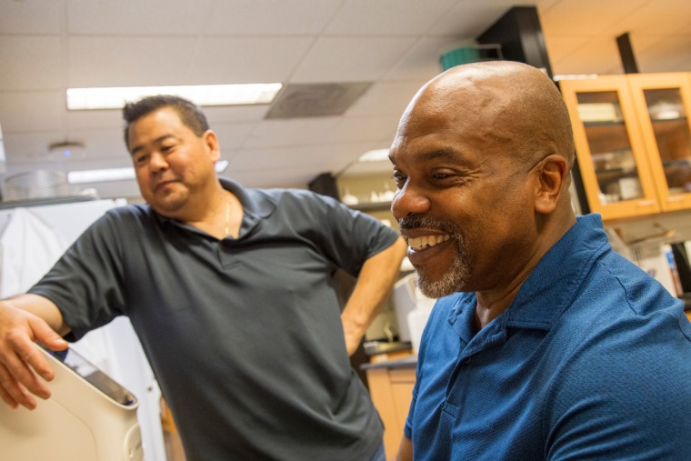Mark A. Nelson, PhD (right), works with research scientist Marc Oshiro, PhD, who performs DNA amplification in a Thomas D. Boyer Liver Institute laboratory.
