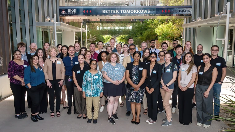 [Attendees at the Share Opportunities & Achievements in Research, or SOAR, in the Department of Medicine forum gather for a group photo between the Biomedical Research Building and Keating BioResearch Building – also the home of the BIO5 Institute.]