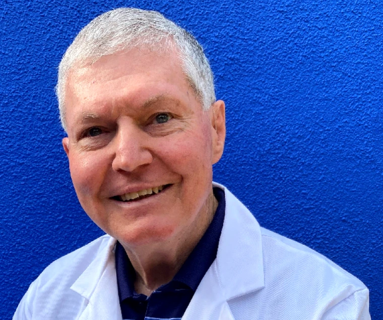 Dr. Hector in front of a blue wall