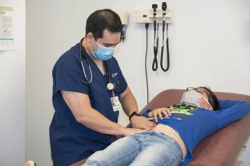 Doctor with patient on examining table