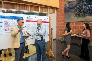 [SAVAHCS associate chief of staff for research and Division of Cardiology associate professor Sandesh Dev, MD, compares notes with Pulmonary Hypertension program director Franz Rischard, DO, at the SOAR in the DOM research forum in the BIO5 Institute.]