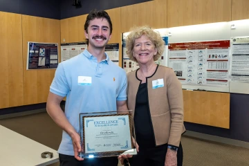 [Janet Funk, MD, the DOM vice chair for research, with Eli Lefkowitz, who won one of the Excellence in Research Awards at the SOAR in the DOM forum April 24 at the BIO5 Institute.]