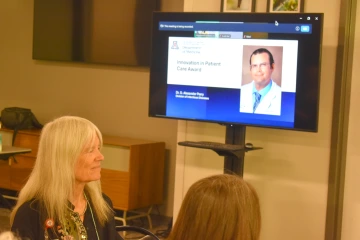 [Image of Alexander Perry, MD, on TV screen at DOM Faculty Awards event, as he was unable to attend]
