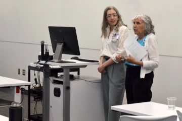 [Mindy Fain, MD (right), offers a few words to the winners as Amy Klein, MD, looks on at the end of the awards ceremony.]