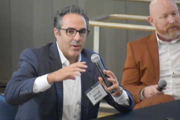 [Jarrod Mosier, MD (left), Clinical Trials Development Workshop co-leader, discusses nuances in how academic success for faculty looks like and various pathways to reach it.]
