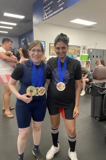[Julia Indik, MD, PhD, at the July USPA meet with fellow powerlifter and U of A College of Medicine – Tucson colleague, Serena Scott, MD, vice chair for faculty development and wellness in the Department of Medicine and an associate professor in the Division of General Internal Medicine, Geriatrics & Palliative Medicine.]